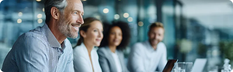 Consultants smiling together in a meeting